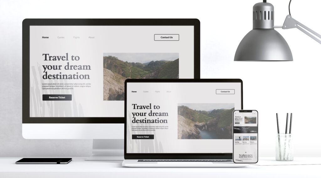 Responsive travel website design displayed on desktop, laptop, and mobile screens.